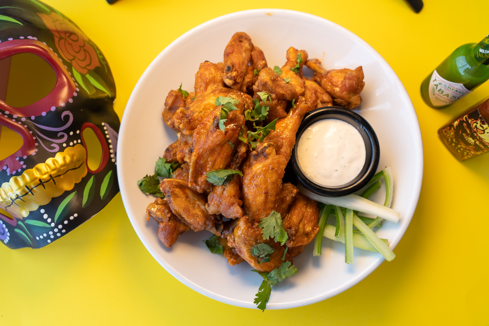 OTB Fried chicken wings tossed in maple chipotle glaze served with ranch sauce.