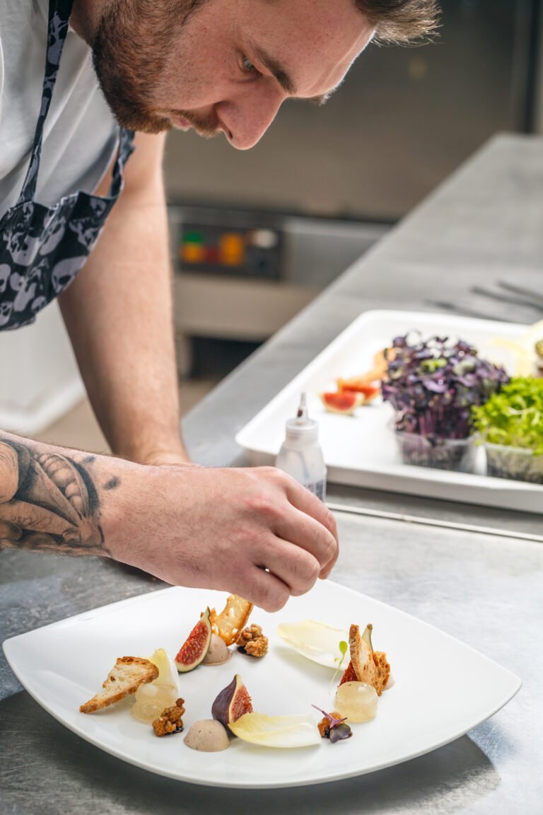 the-chef-is-garnishing-appetizer-dish-PDHYM4B